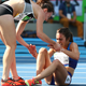 Abbey D'Agostino of the United States (R) is assisted by Nikki Hamblin of New Zealand after a collision during the a heat in the Women's 5000m at the Rio 2016 Olympics.
